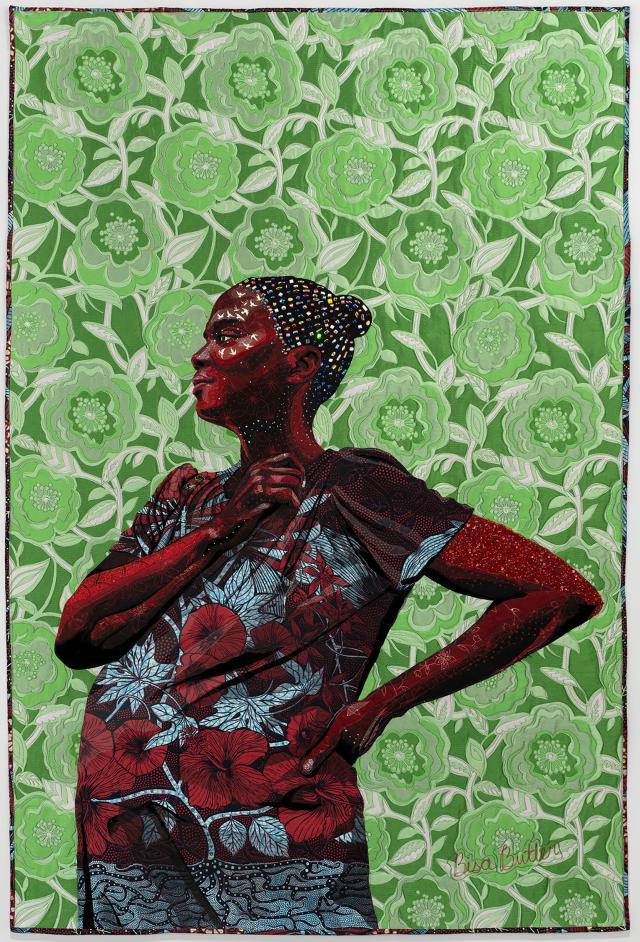 Quilt of a woman looking into the distance on a green background.