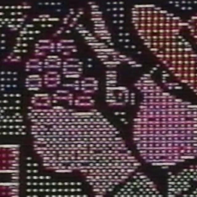 A video still of a person in a sombrero picking grapes.