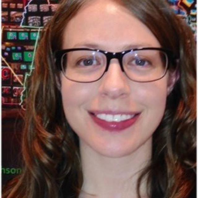 A photograph of Anne Showalter in front of Superhighway. 