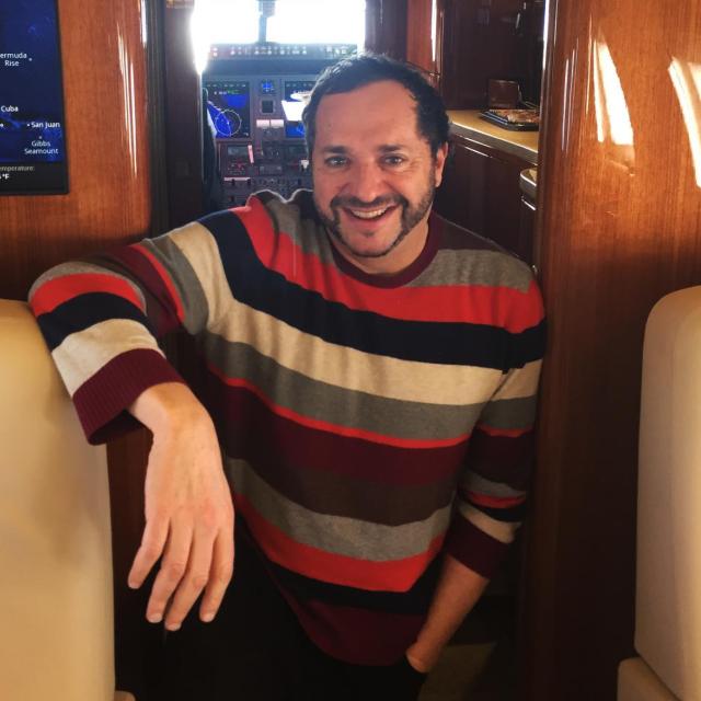 A photograph of Howard Kaplan on a plane.
