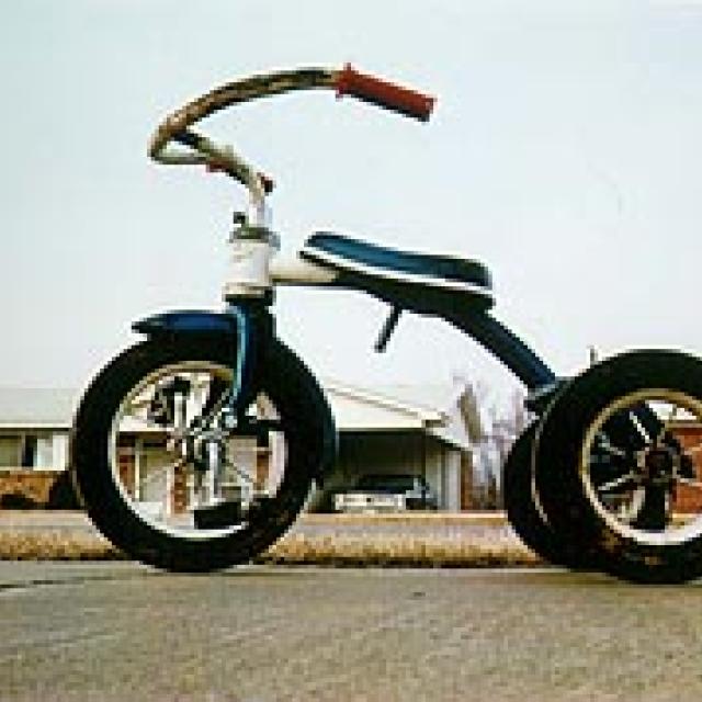 A photograph of a tricycle at a low angle