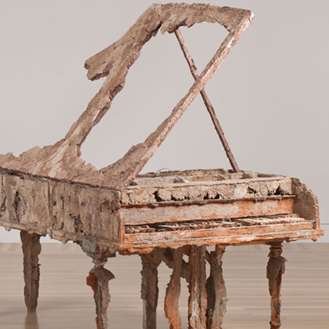 An image of a piano made of clay. 