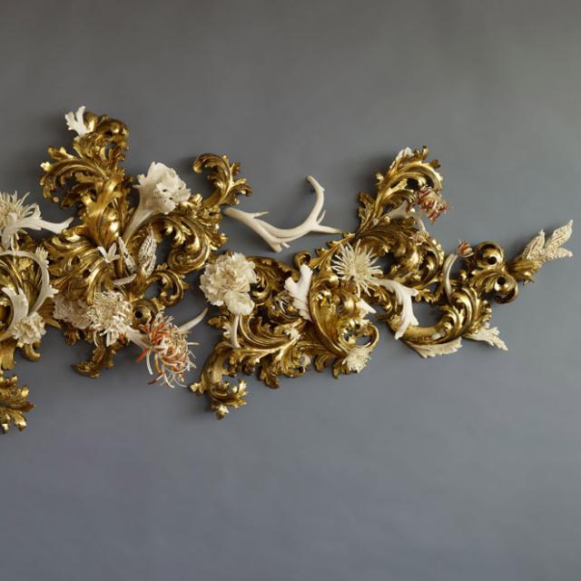 An image of a sculpture made of various materials and painted gold. 