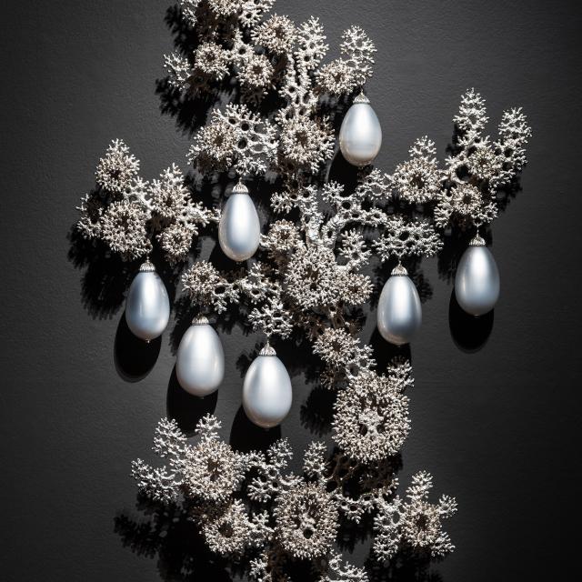abstract shapes painted in silver with seven silver ornaments.
