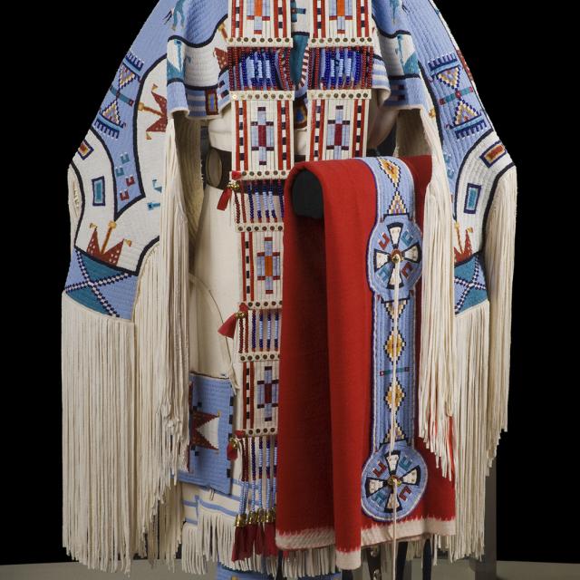 A traditional dress in white, blue, red, and black