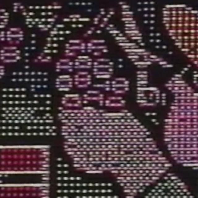 A video still of a person in a sombrero picking grapes.