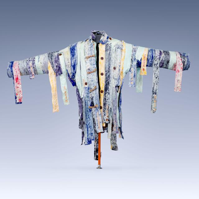 A sculptural jacket made of strips of fabric, which hang down.