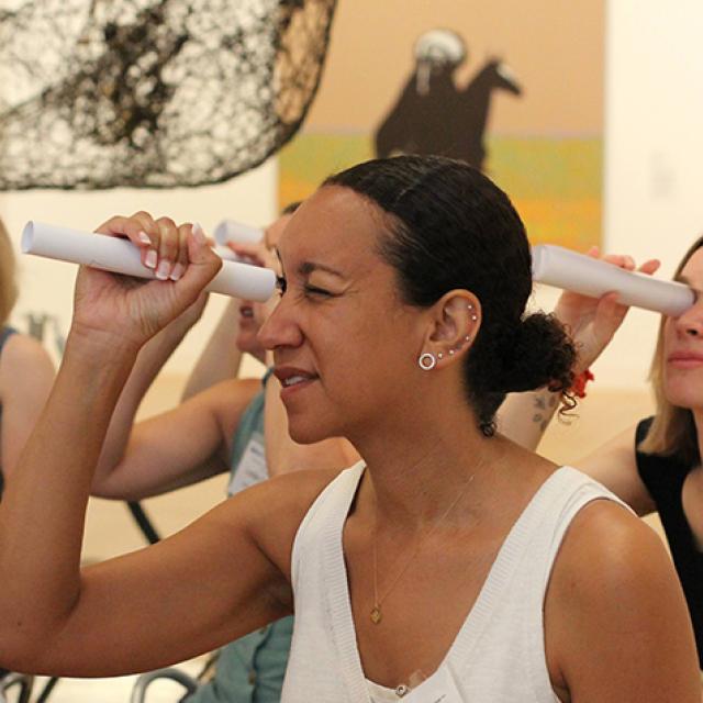 Teachers use rolled pieces of paper as telescopes.