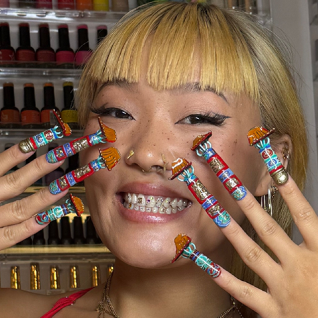 Artist Ameya Okamoto posing with her nail art.