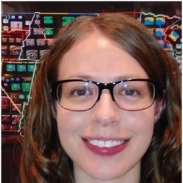 A photograph of Anne Showalter in front of Superhighway. 