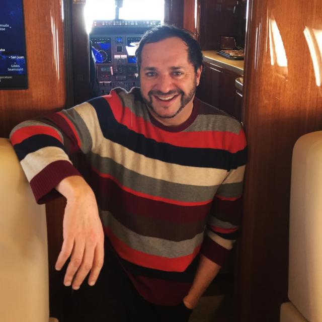 A photograph of Howard Kaplan on a plane.